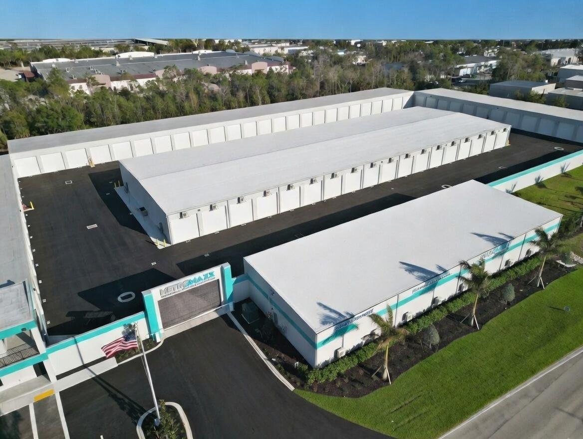 Drone aerial view of MetroMaxx RV and Boat Storage facility showing private climate-controlled storage units, wide concrete drive aisles, and secure perimeter in Fort Myers, Florida.