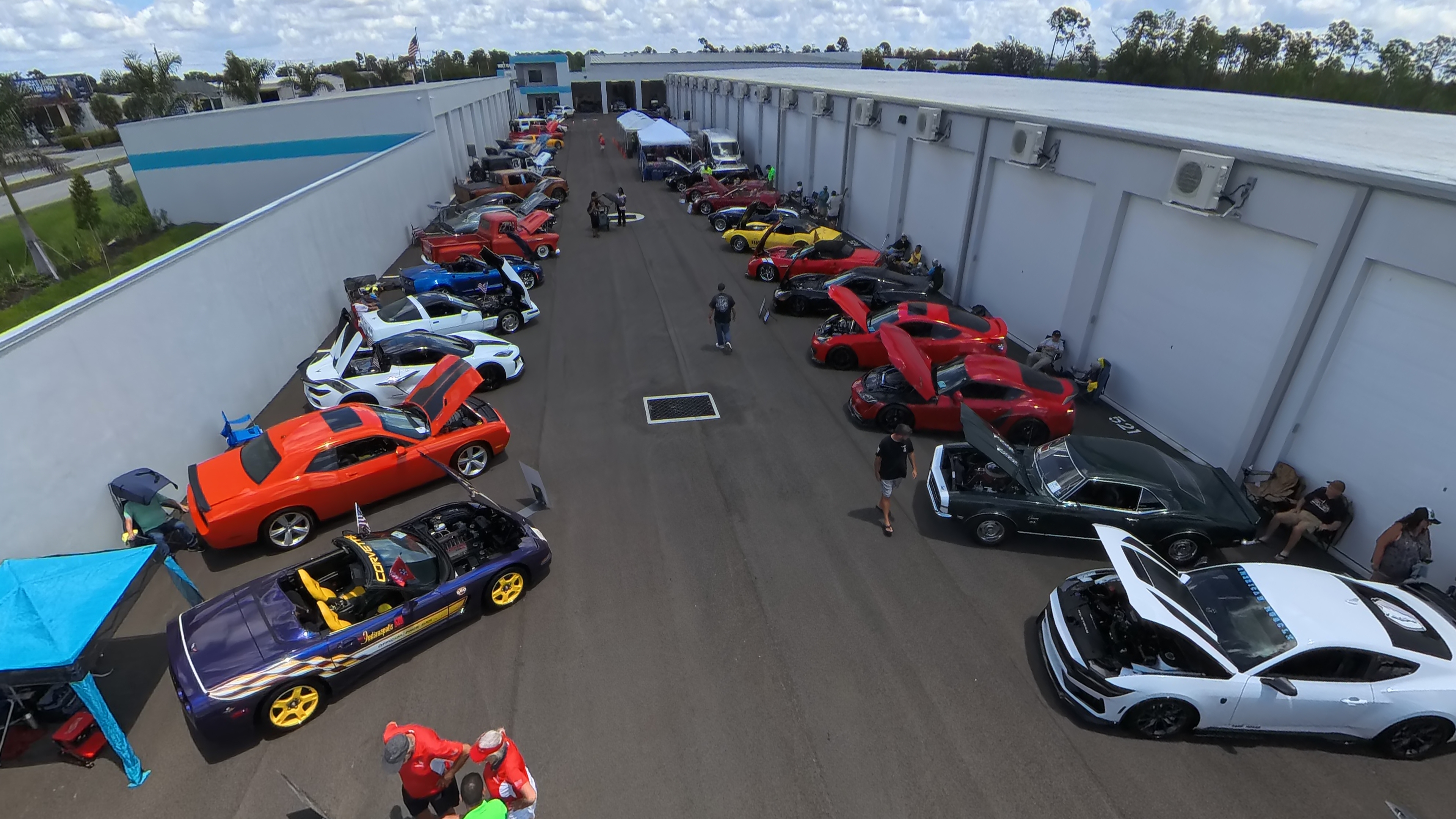 MetroMaxx Car, Truck & Jeep Show - May 17, 2026 Aerial view of the MetroMaxx Car, Truck & Jeep Show held on May 17, 2026, showing dozens of classic and modern cars lined up along both sides of the wide concrete drive aisle inside the climate-controlled storage facility in Fort Myers, Florida.