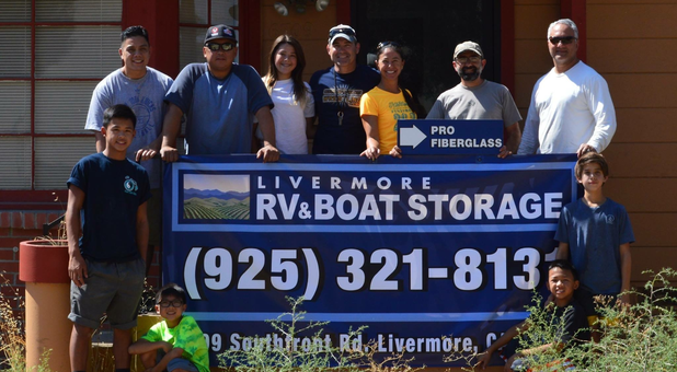 Livermore RV & Boat Storage people holding sign