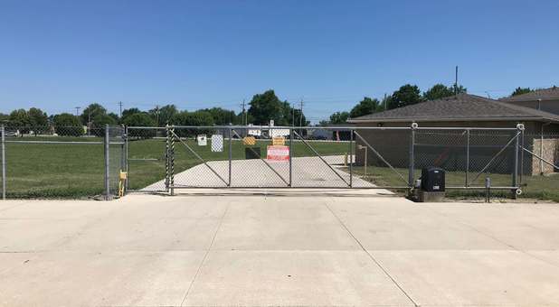 view of gated entrance from inside the facility, keypad on entrance side Keypad controlled gated entrance into storage units at Stop-N-Stor Northwood