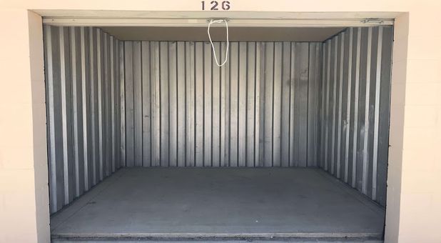 inside look in an empty, metal storage unit with a rollup door at Stop-N-Stor Northwood Inside look into one of our storage units at Stop-N-Stor Northwood