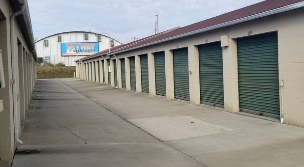 storage facility with storage units with green doors next to Skyway recreation center building Stop-N-Stor - Oregon is located next to Skyway Recreation Center
