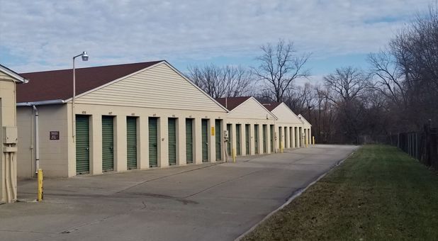 pictured, 3 buildings with outside storage lockers with green doors Stop-N-Stor - Oregon offers storage units and lockers with drive up access