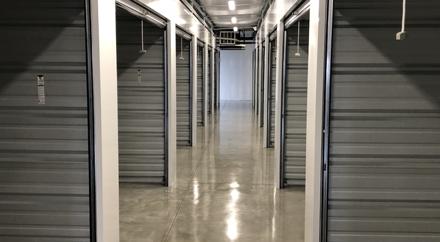 hallway of self storage facility, units all have open doors