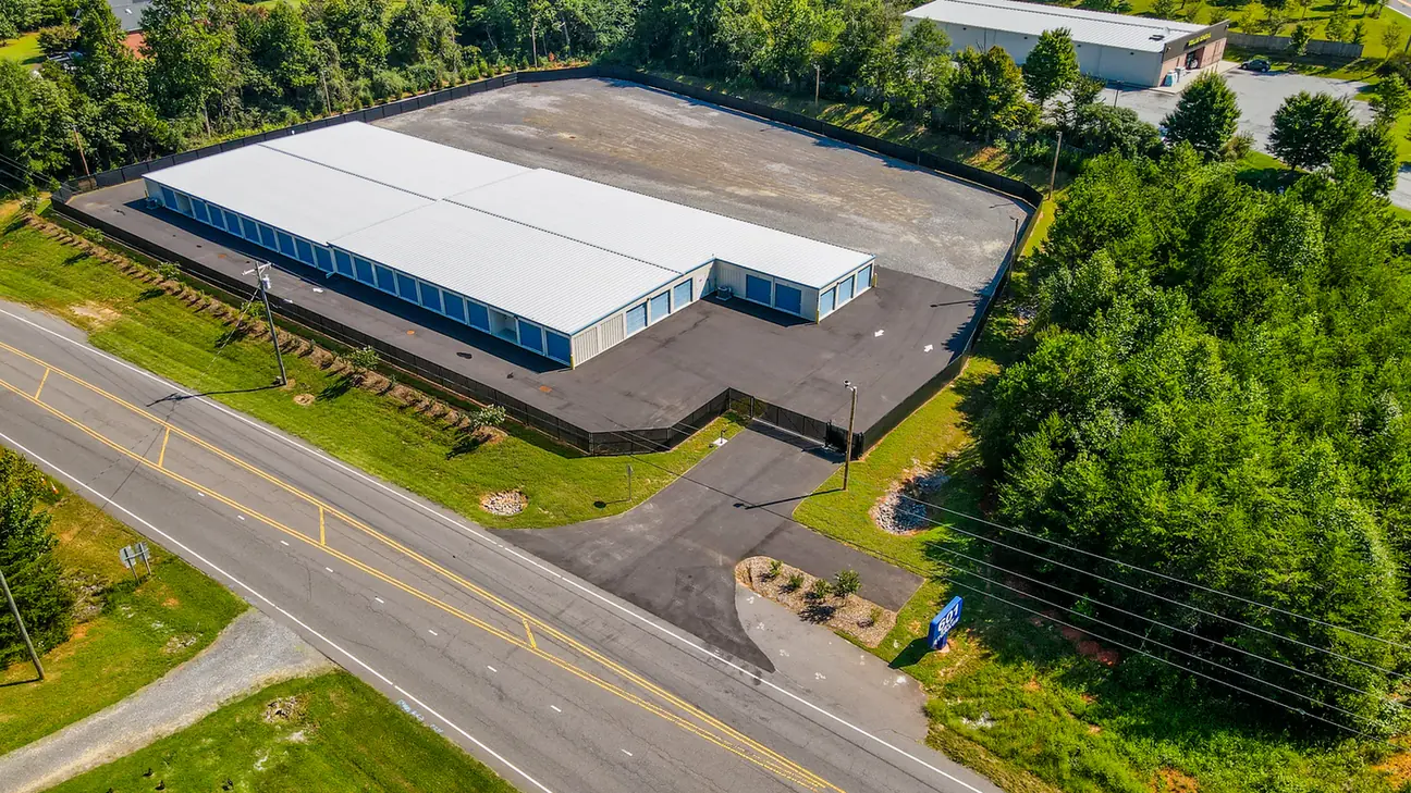 Aerial view of the full 601 Self Storage facility on US Highway 601 in Mocksville, NC, with the entrance gate and road sign