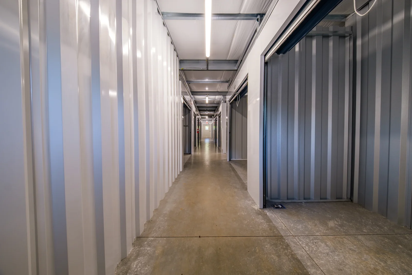 Lit climate-controlled hallway with ground-floor storage units at 601 Self Storage