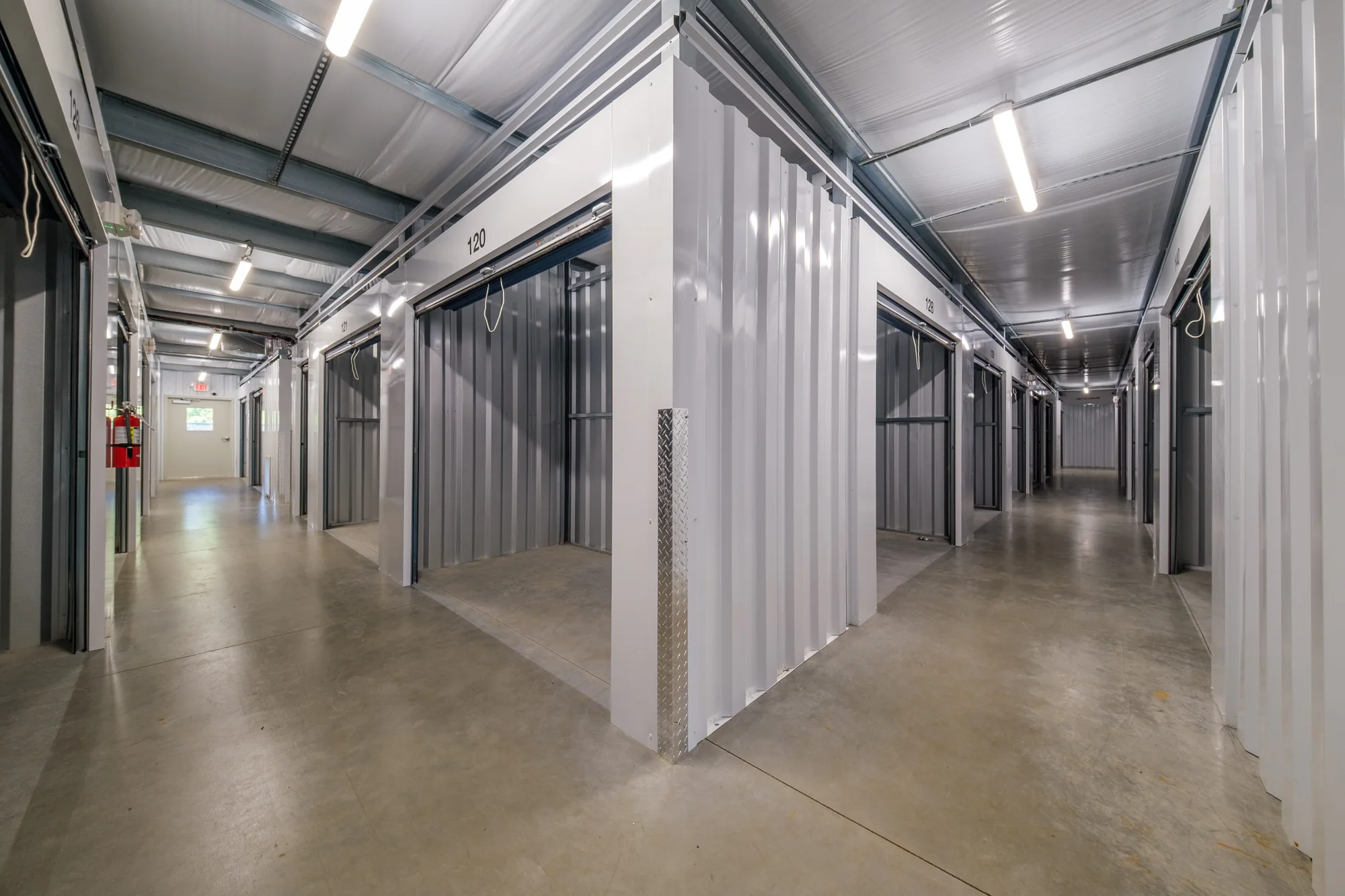Bright, clean climate-controlled hallway inside 601 Self Storage with unit 120 open