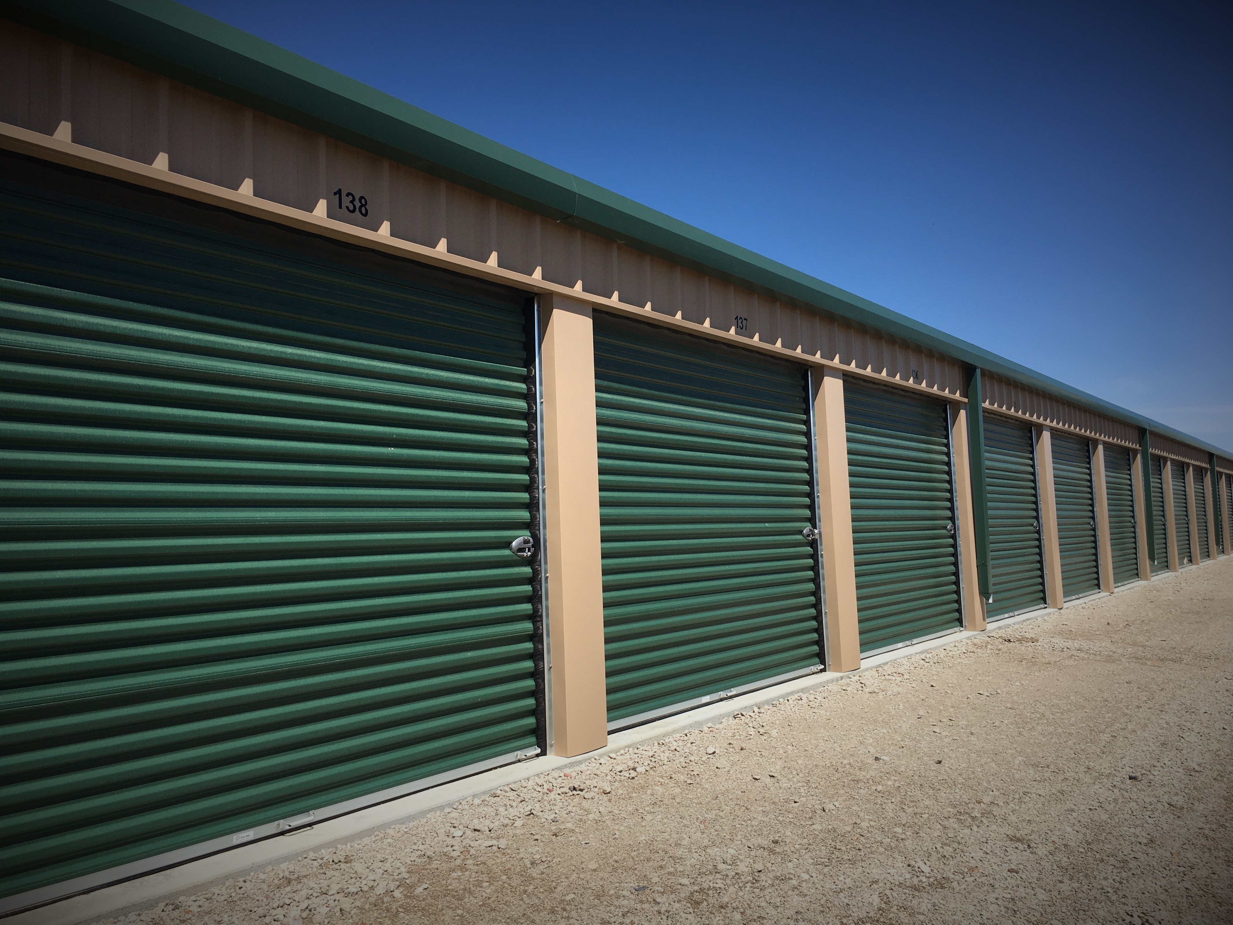 photo of a row of storage units with 9x7 roll-up doors