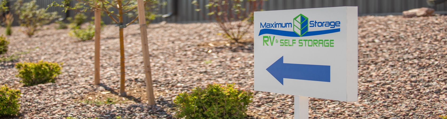 Maximum Storage RV & Self Storage signage with arrow pointing direction to facility