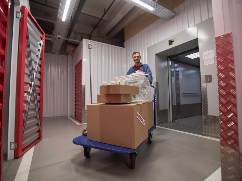 man-taking-boxes-from-commercial-storage-unit