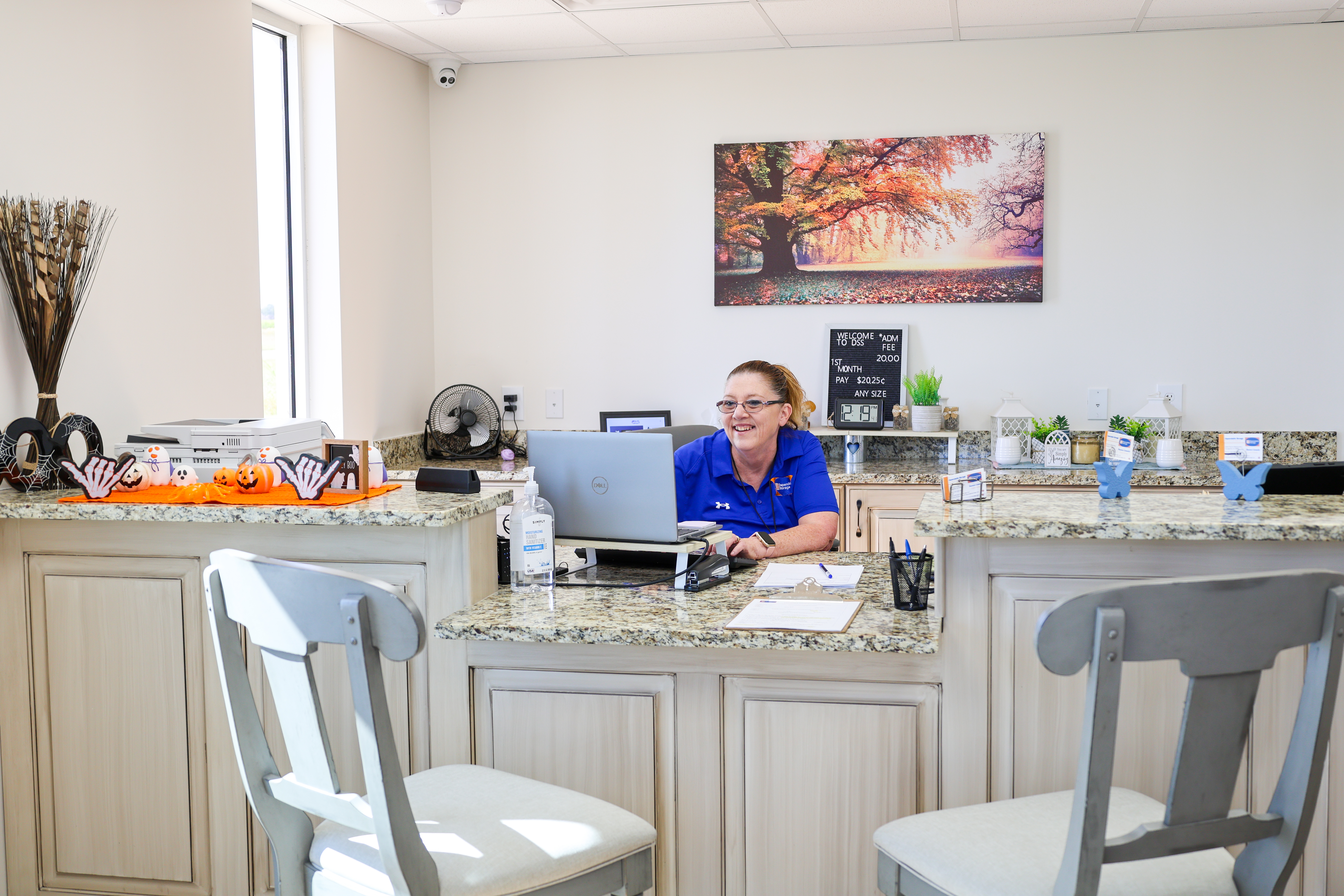 Friendly manager assisting a customer inside the Dependable Storage Youngsville office