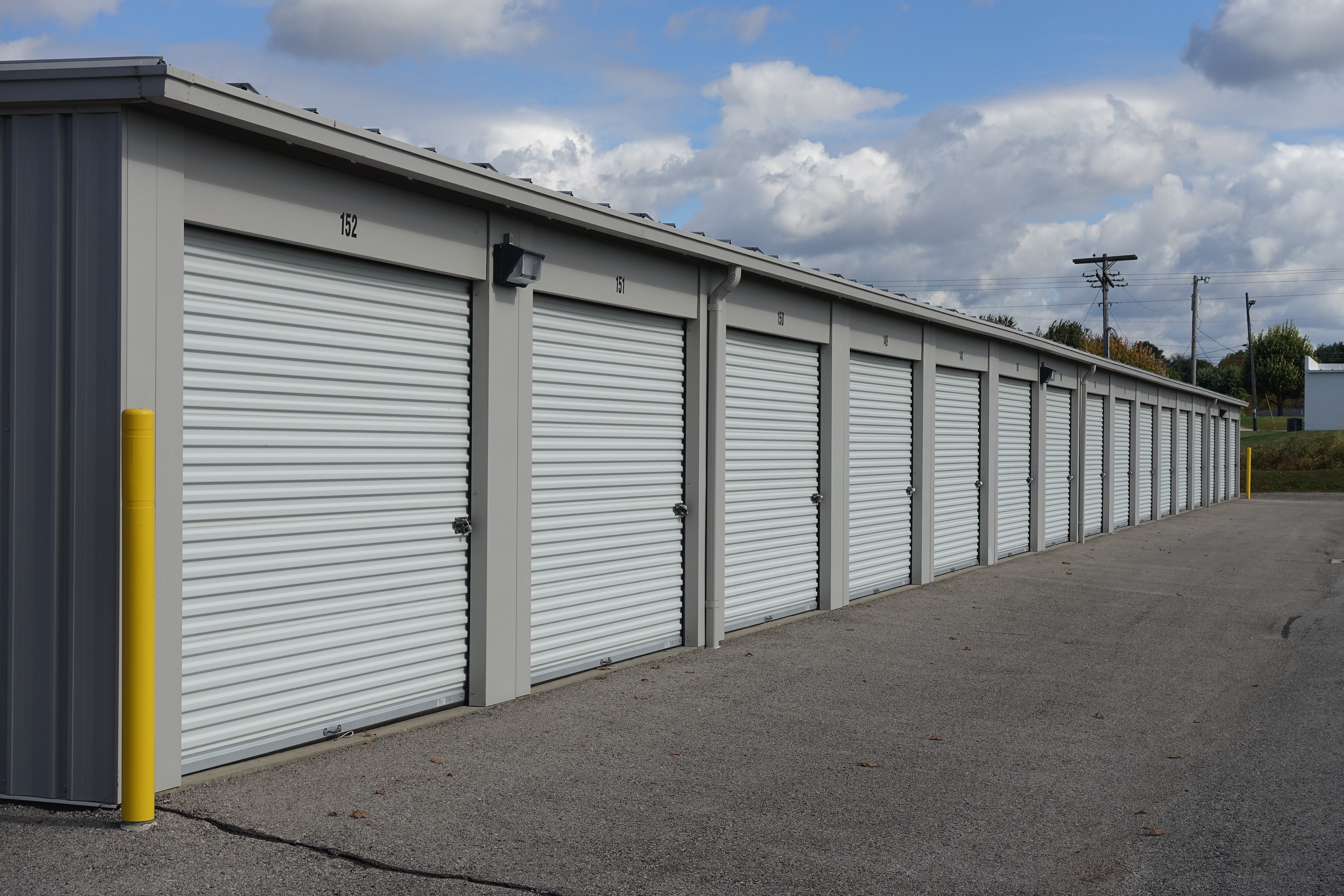 Spacious storage options in a variety of sizes, all with white doors and ample driveway space at Mississippi St Access Storage.