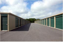 Self storage facility in Indiana with paved driveway, green doors, 24/7 access, and great customer service.