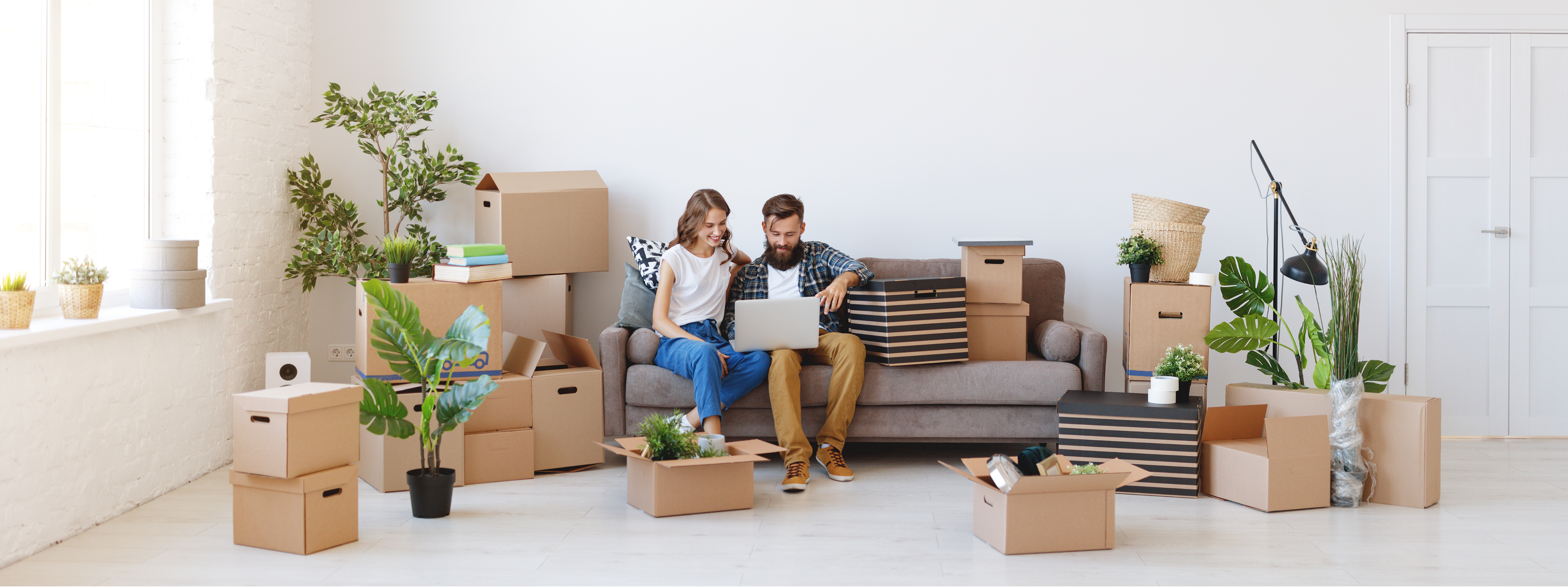 people sitting among moving boxes