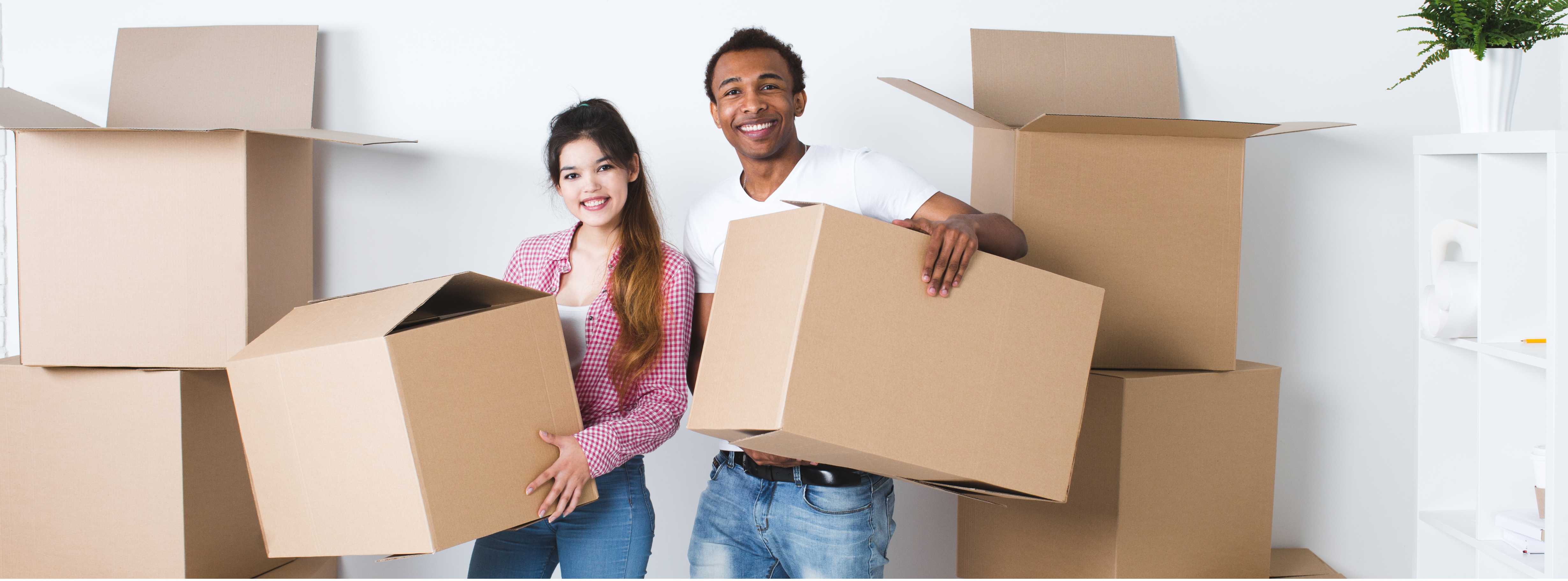 two people holding moving boxes