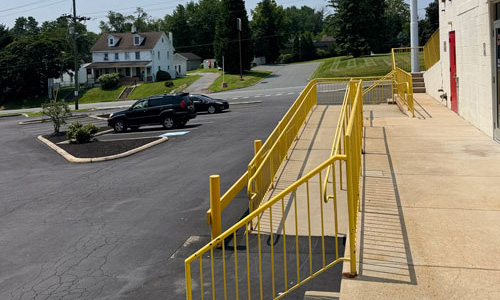 Exterior photo showing stairs and ramp in front of building