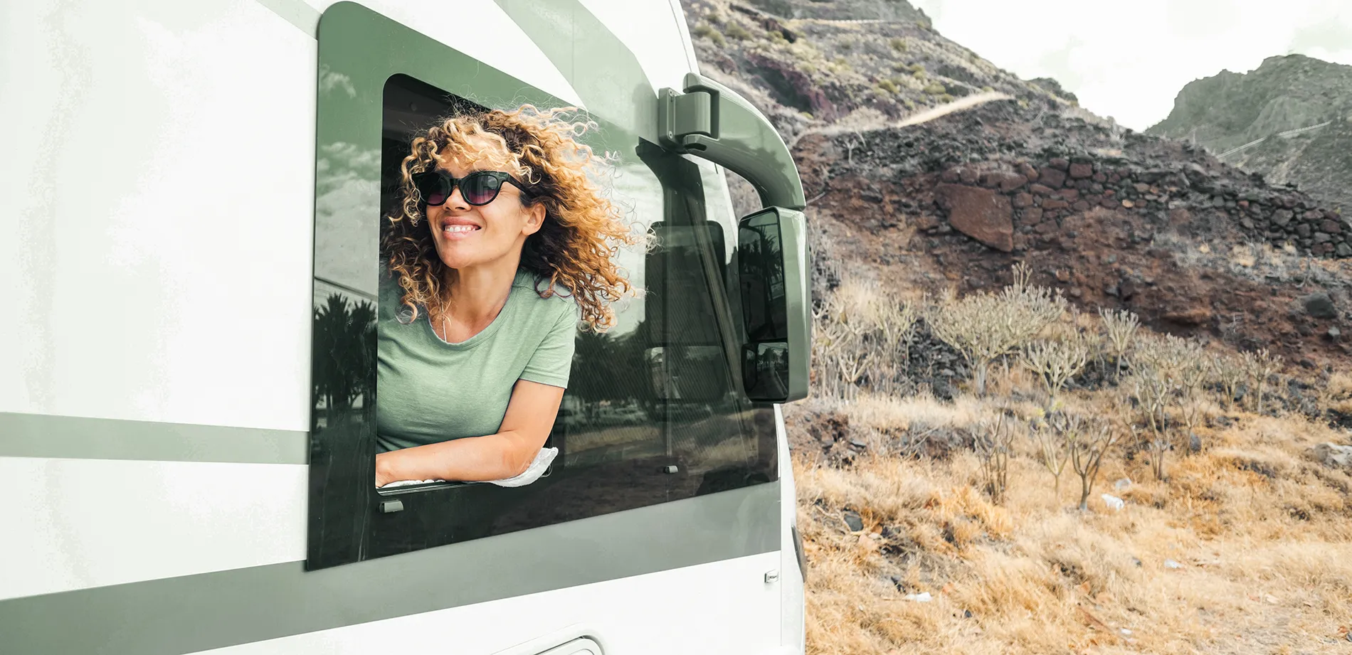 Woman looking out window of RV