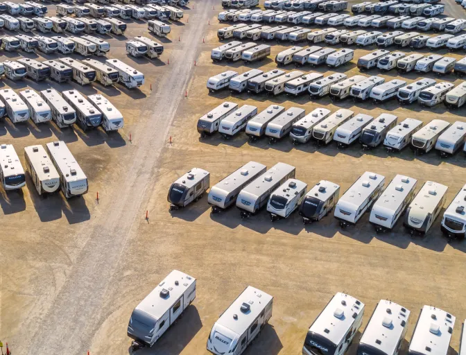 Many RVs parked in a large lot