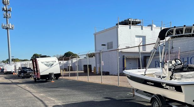 Outdoor, uncovered fence line RV, boat, and car parking