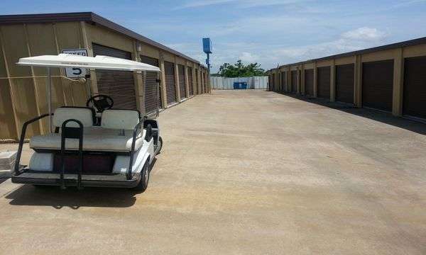 golf cart parked in front of storage buildings with drive up access